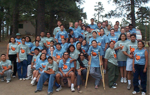 larger group of native americans at an event, posing and smiling